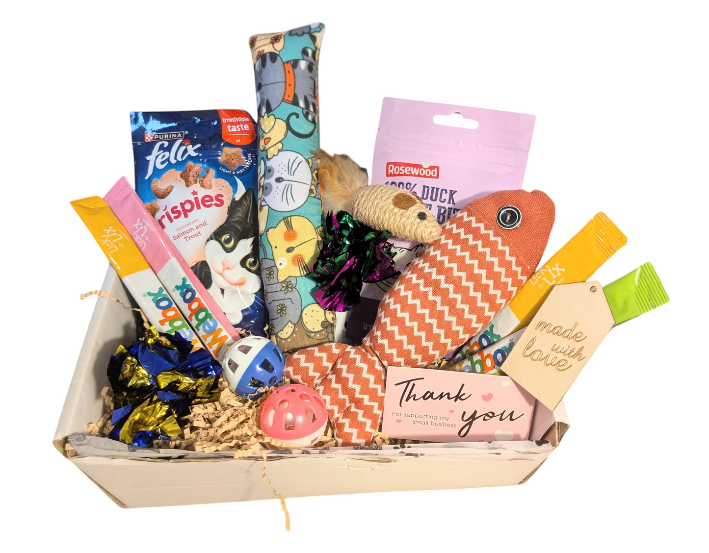 Gift basket with pet toys and treats on a white background