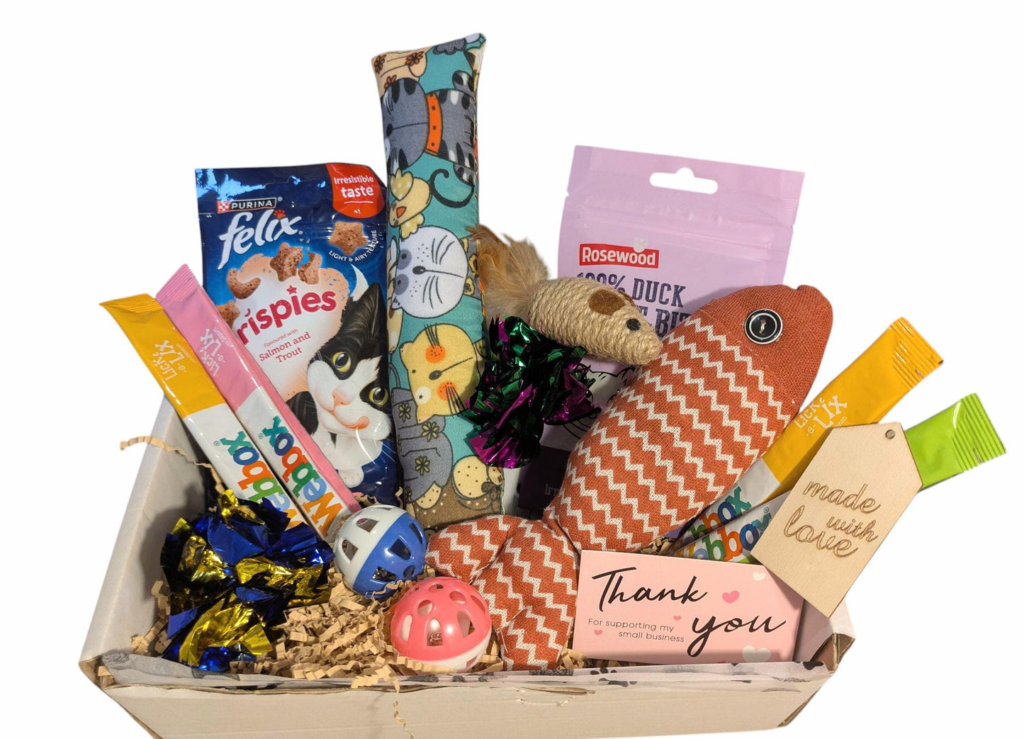 Cat gift basket with various cat treats, toys, and products on a white background