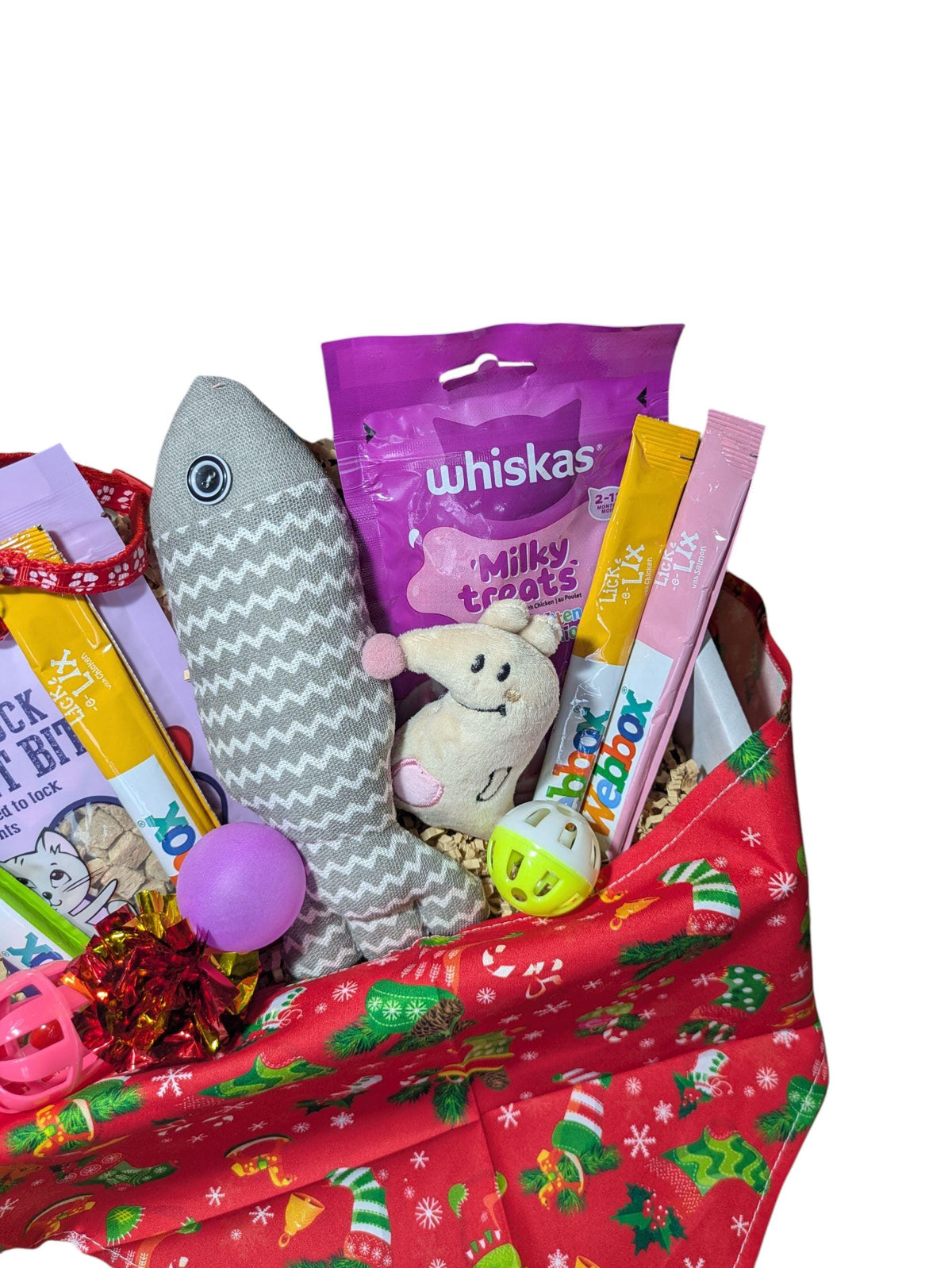 Festive red box filled with cat treats, including a plush fish toy, Whiskas milk treats, and a small plush mouse with a bell.