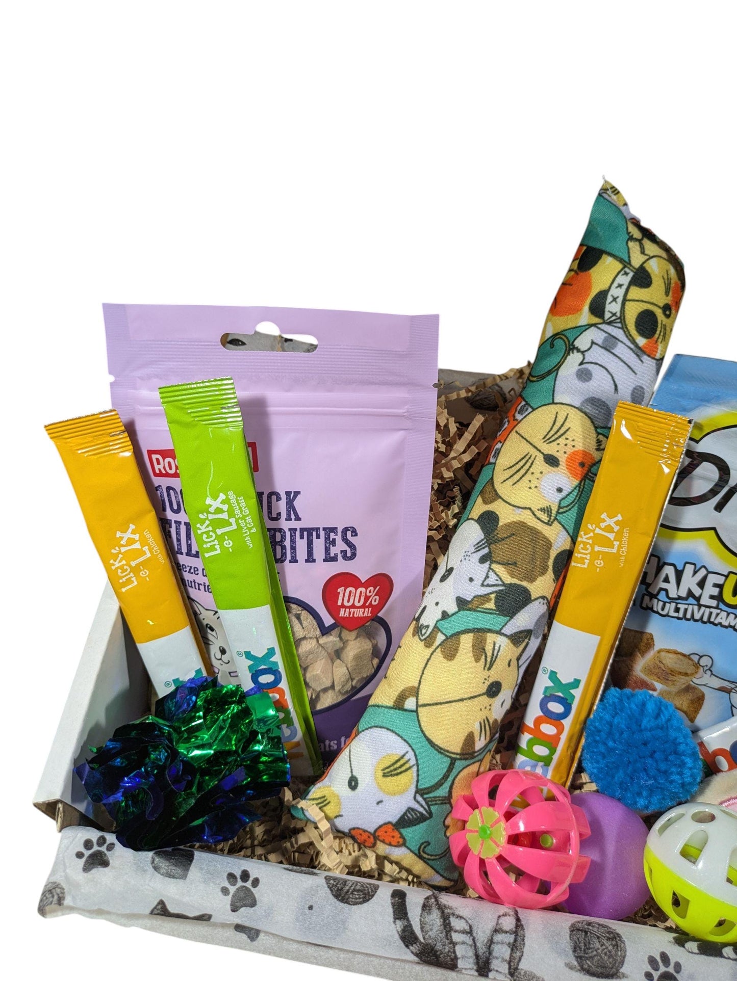 Personalised cat treat box with colorful catnip toys including a fish-shaped pillow and assorted treats.
