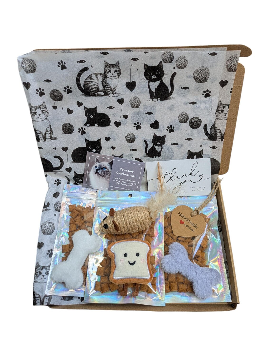 Cat-themed gift set with plush toys and cat treats in a box