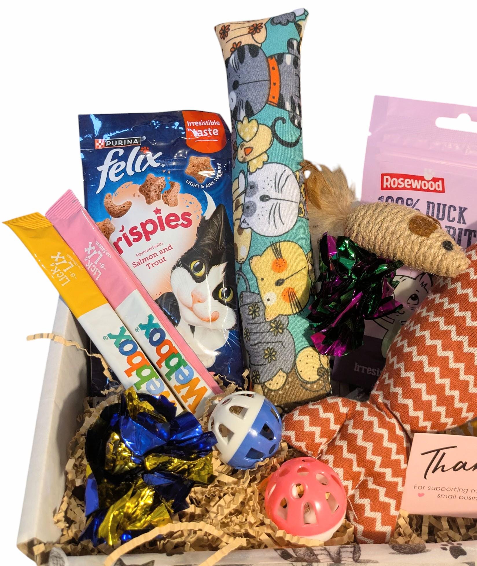 Assorted cat products including treats, toys, and a box on a white background