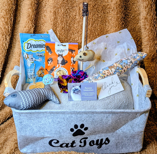 Cat toy basket with various cat toys and treats on a textured brown background
