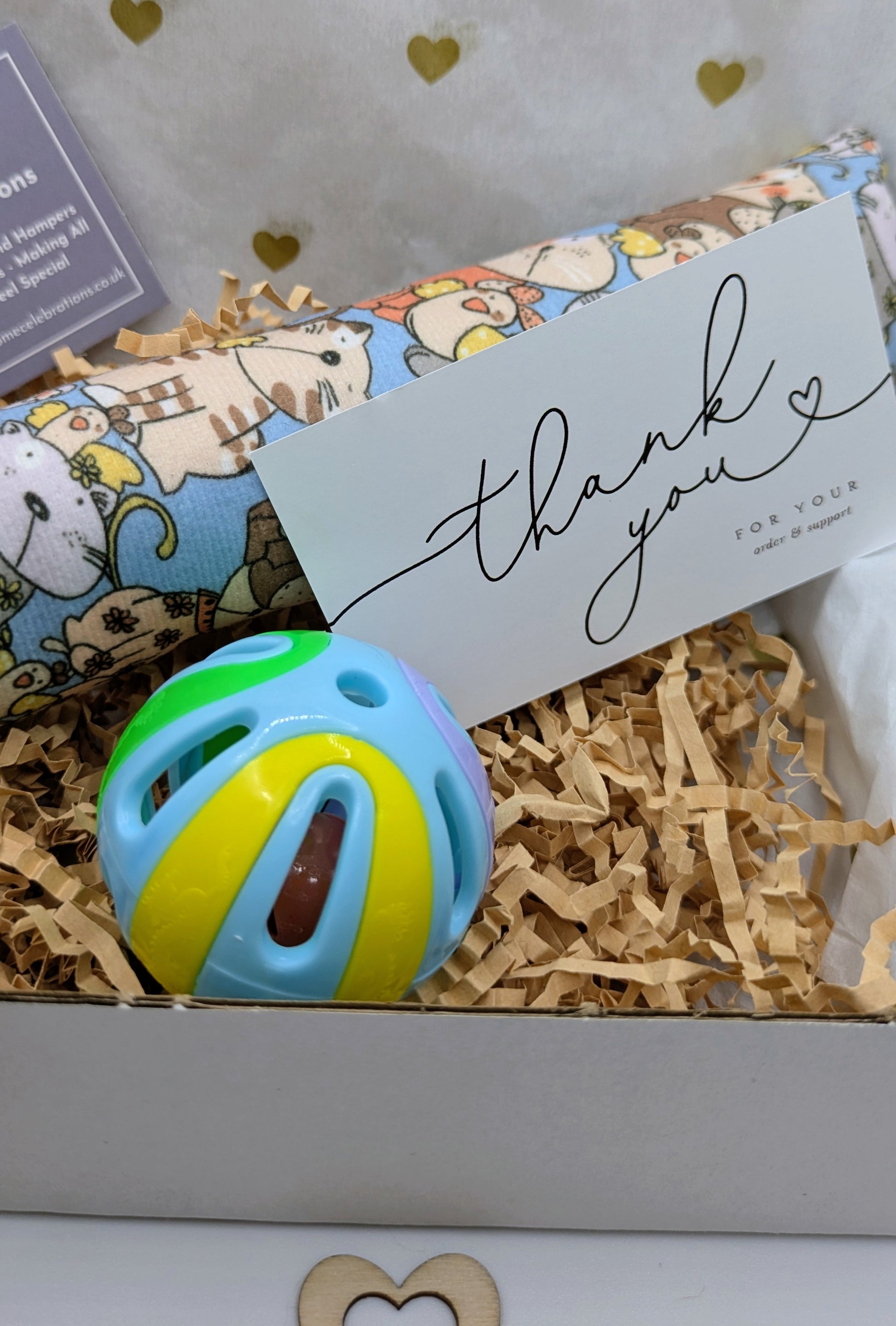 Colorful cat toy in a gift box with a 'thank you' card.
