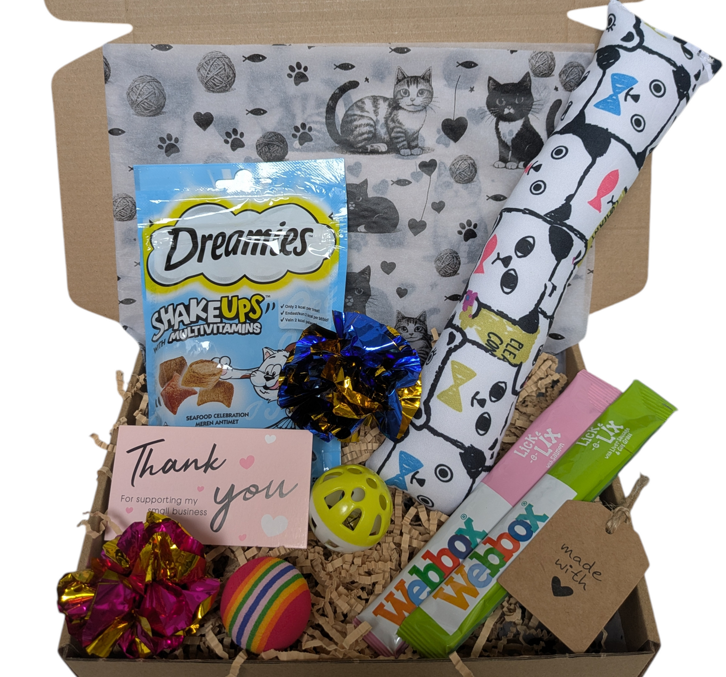 Cat-themed gift box with various items including a bag of cat treats, toys, and a blanket.