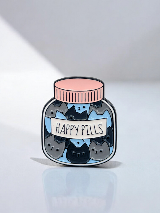 Enamel pin of a jar labeled 'Happy Pills' filled with kawaii cartoonish cats on a light gray background