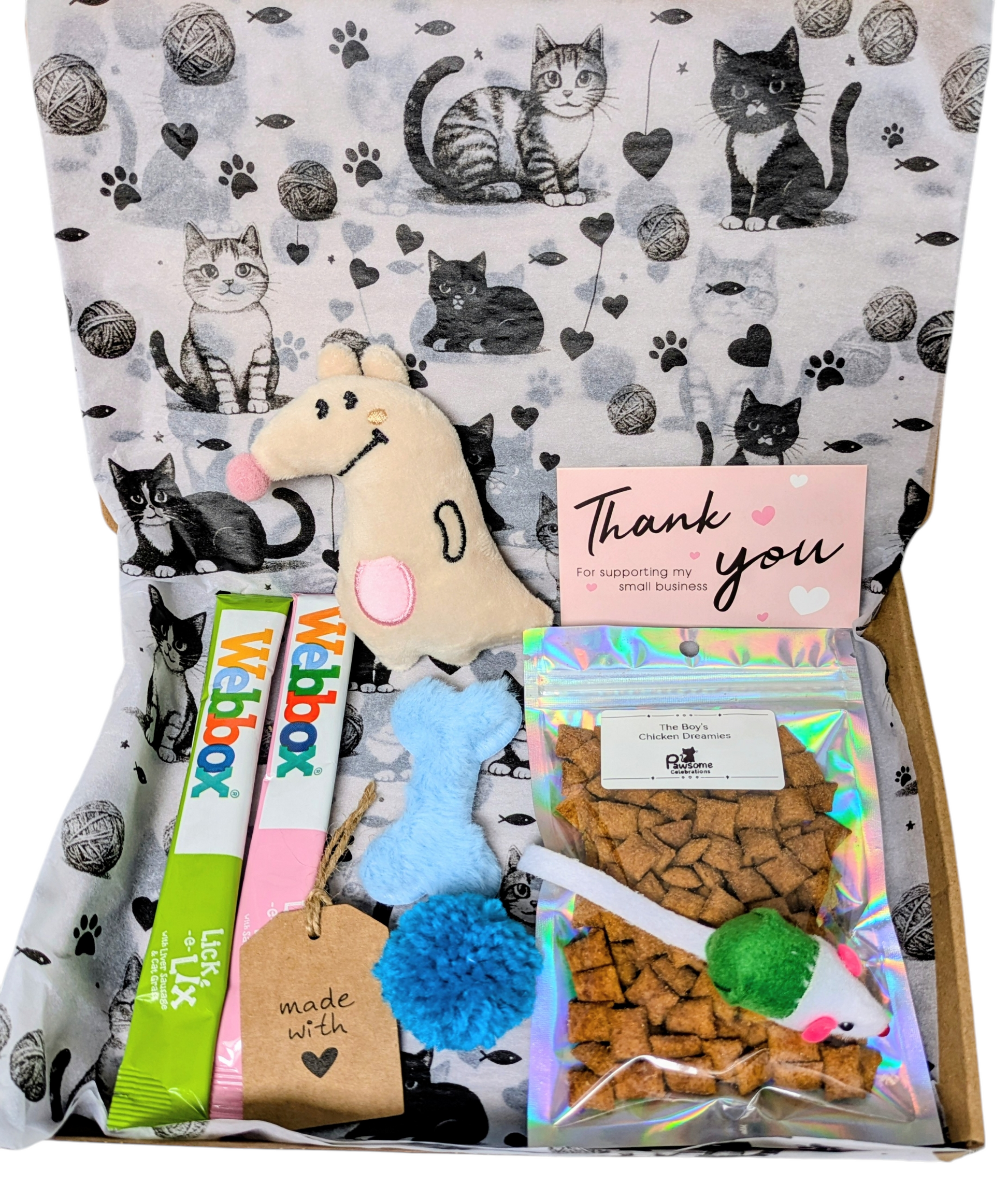 Cat-themed gift box with treats, toys, and a Webbox branded product on a patterned background.