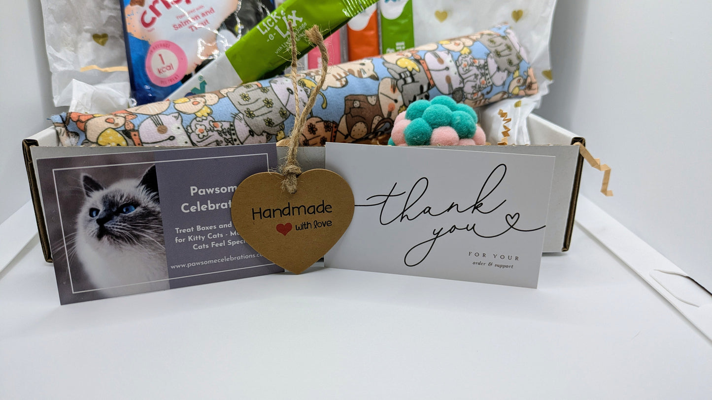 Cat-themed gift set with a card and decorative elements on a white surface