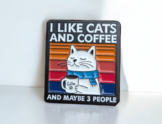 Enamel Pin with a cat illustration and text 'I like cats and coffee and maybe 3 people' on a white background