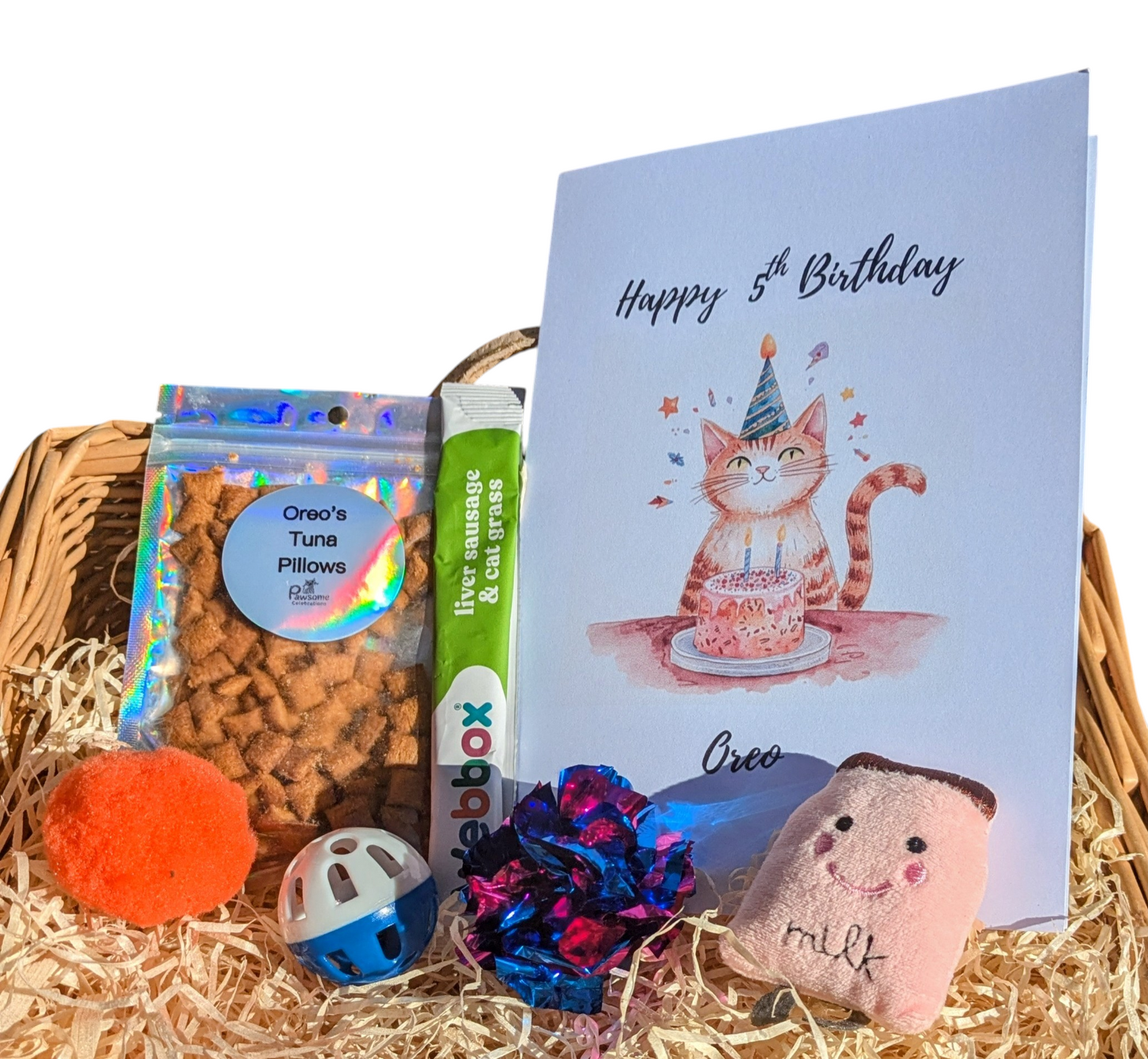 Cat-themed birthday gift basket with a card, treats, and toys.